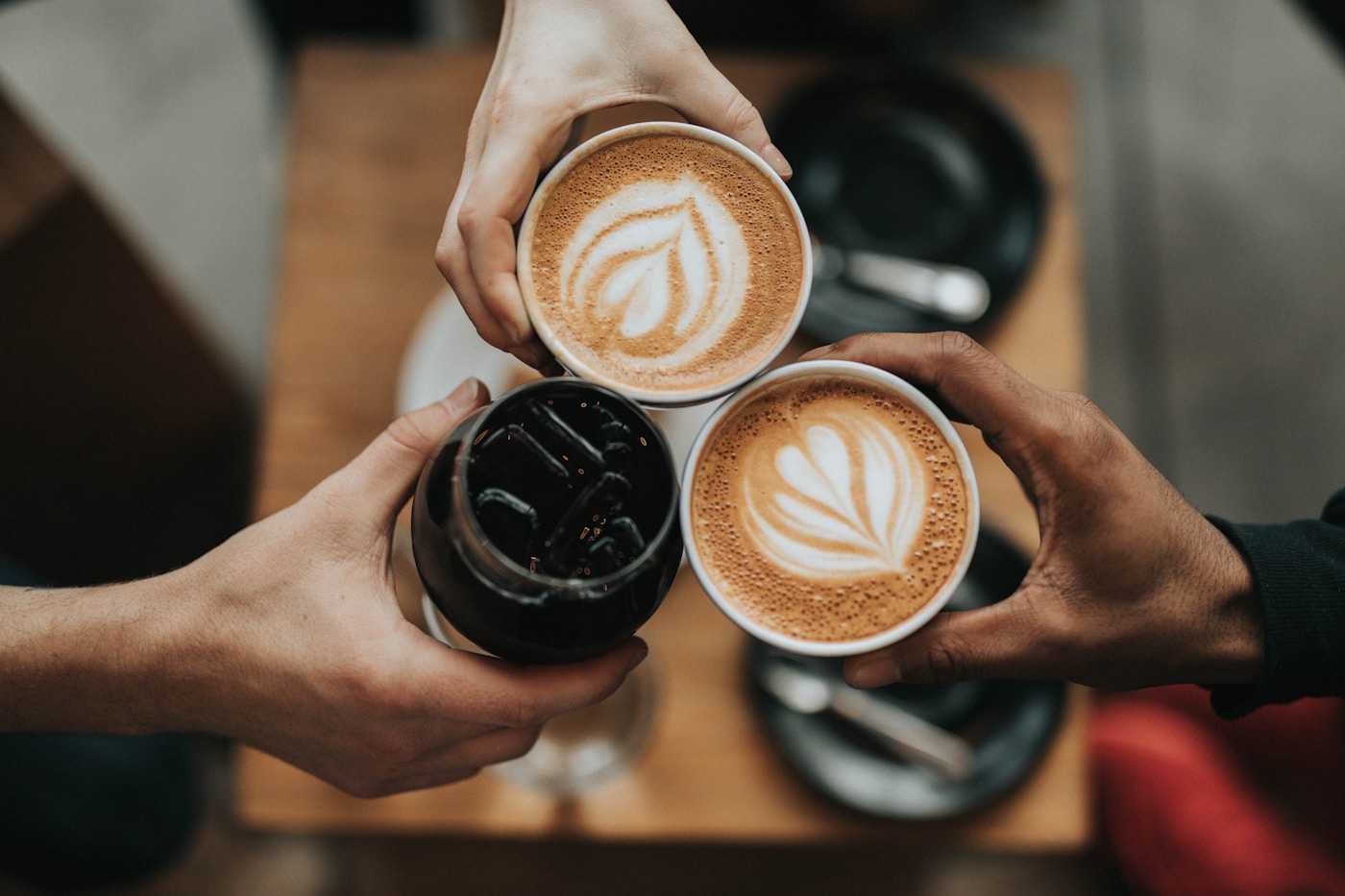 Close-up of a cup of kopi on a wooden table